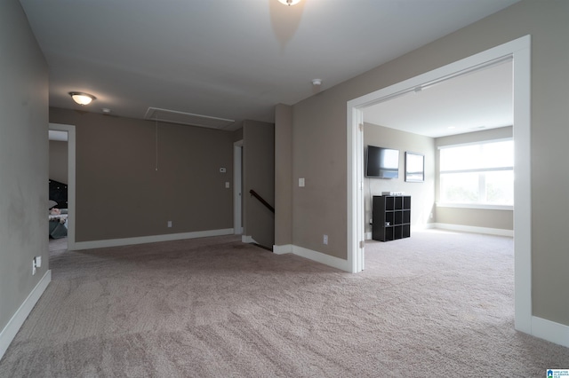 unfurnished living room with light colored carpet