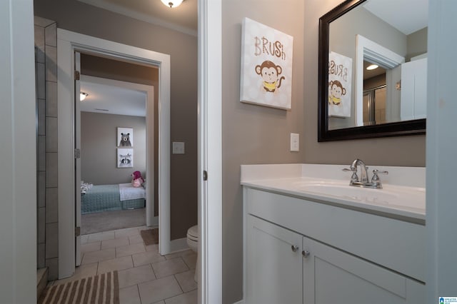 bathroom featuring toilet, tile patterned flooring, and vanity