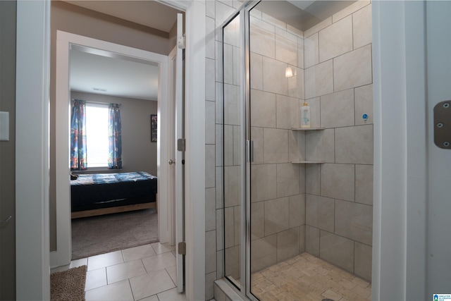 bathroom with tile patterned floors and a shower with door