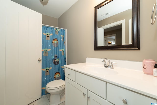 bathroom with toilet, tile patterned floors, and vanity