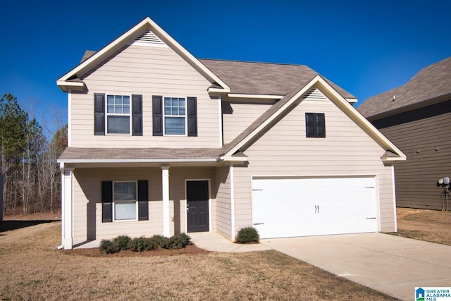 view of front of property with a garage, a front lawn, and covered porch