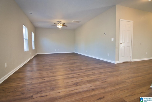 empty room with ceiling fan and dark wood-type flooring