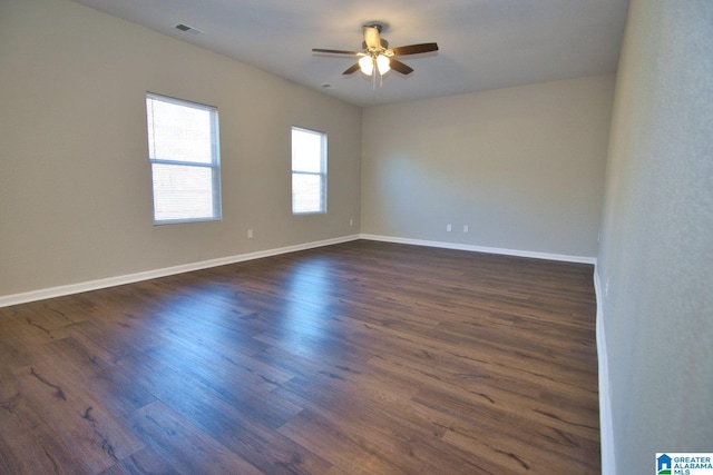 spare room featuring ceiling fan and dark hardwood / wood-style floors