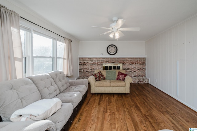 living room with a fireplace, hardwood / wood-style floors, ceiling fan, and crown molding