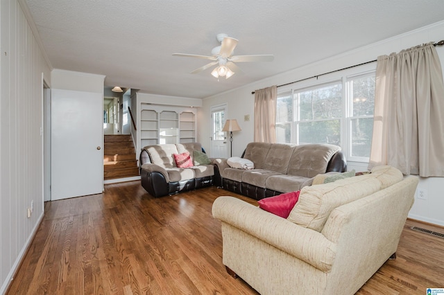 living room featuring hardwood / wood-style floors, a textured ceiling, and ceiling fan