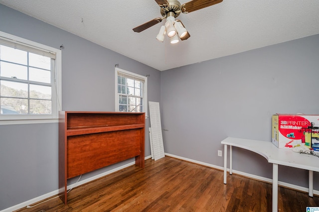 interior space with ceiling fan, hardwood / wood-style floors, and a textured ceiling