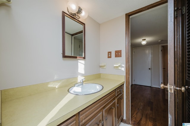 bathroom featuring wood-type flooring, a textured ceiling, and vanity