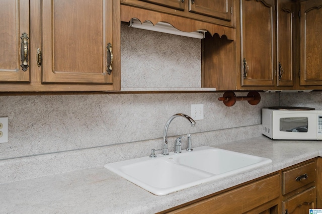 kitchen featuring sink and backsplash