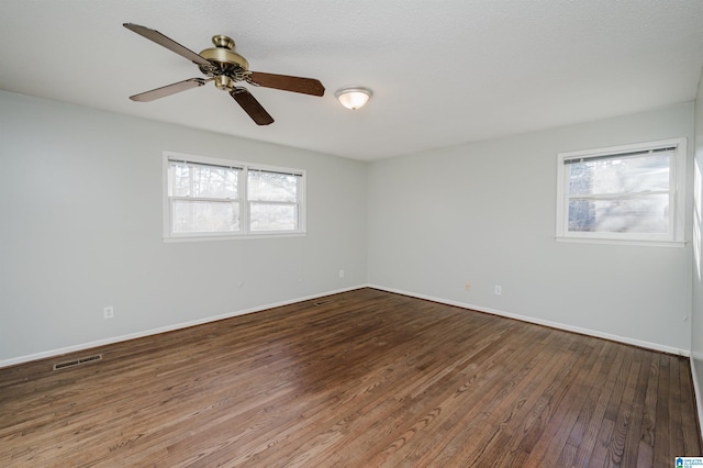 unfurnished room featuring hardwood / wood-style floors and plenty of natural light