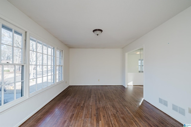 spare room with dark hardwood / wood-style flooring