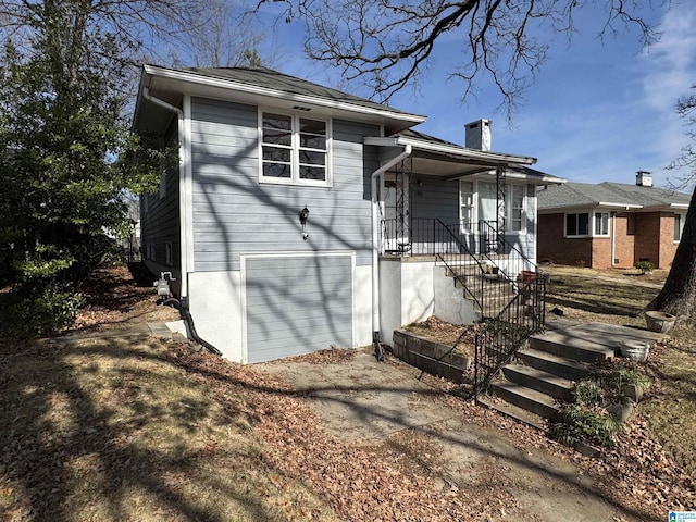 back of house with a garage