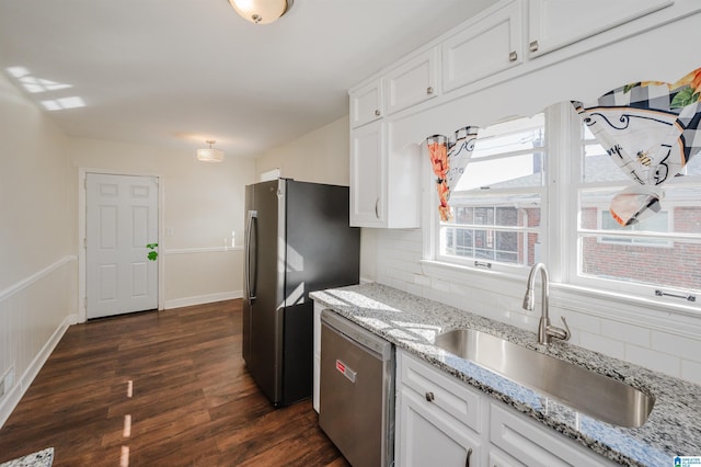 kitchen with white cabinetry, stainless steel appliances, sink, and tasteful backsplash