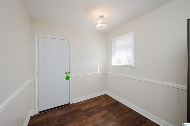 empty room with dark hardwood / wood-style flooring