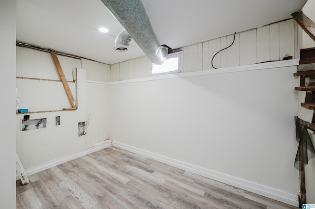 laundry room featuring washer hookup and light hardwood / wood-style floors