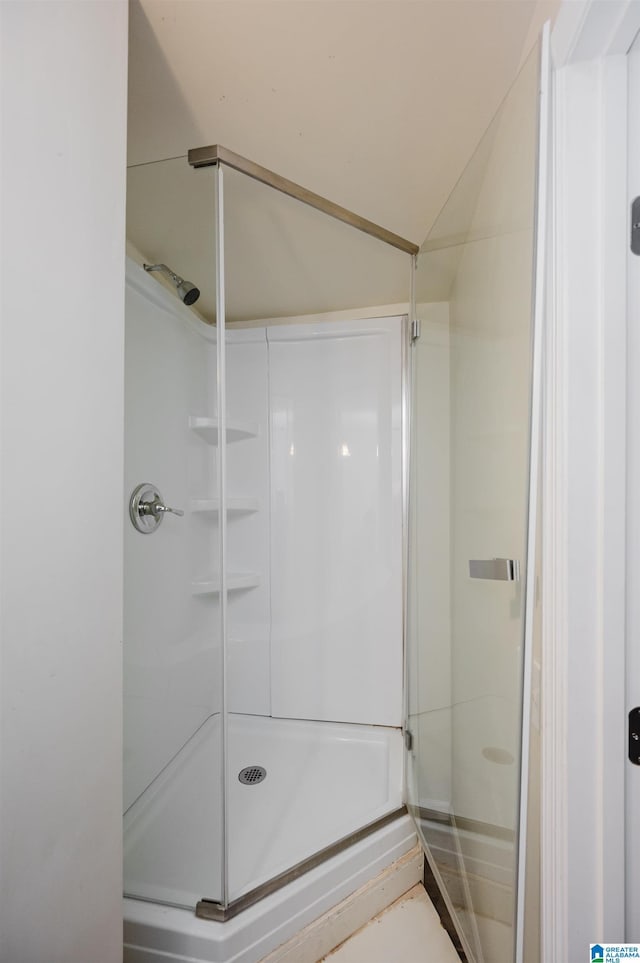 bathroom with vaulted ceiling and walk in shower