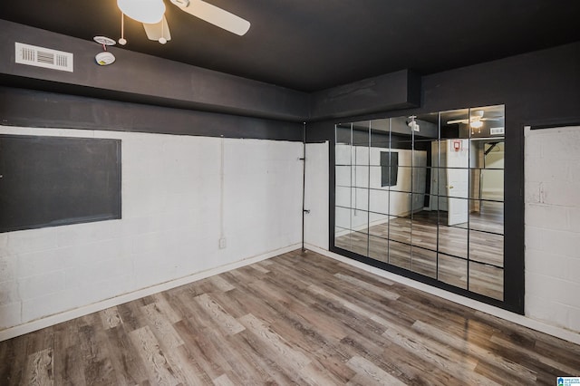 unfurnished room with ceiling fan and wood-type flooring