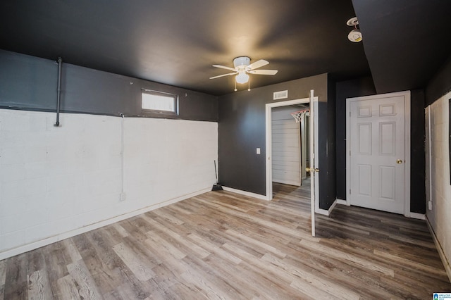 unfurnished bedroom featuring hardwood / wood-style floors, ceiling fan, and a closet