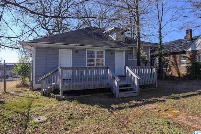 exterior space with a wooden deck and a front lawn