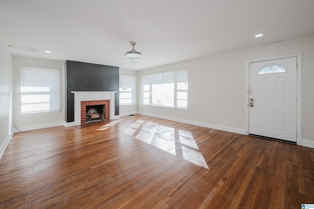 unfurnished living room with hardwood / wood-style floors and a fireplace