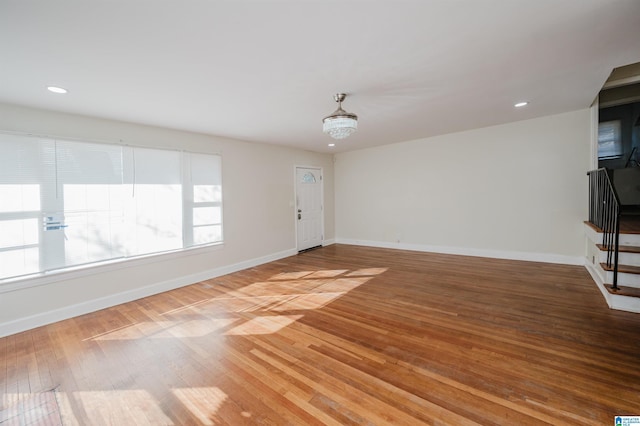 unfurnished living room with hardwood / wood-style flooring