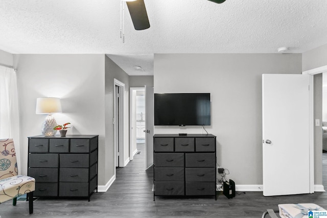 bedroom featuring a textured ceiling, dark hardwood / wood-style floors, connected bathroom, and ceiling fan