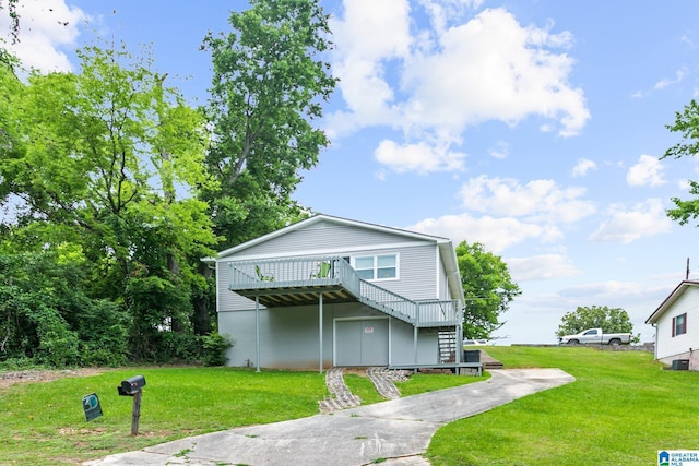 view of front of home with a wooden deck and a front yard