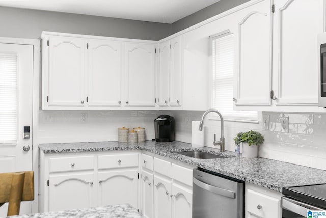 kitchen with sink, white cabinetry, and dishwasher