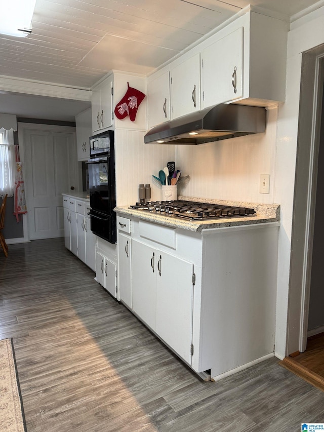 kitchen with stainless steel gas cooktop, dark wood-type flooring, white cabinetry, and black oven