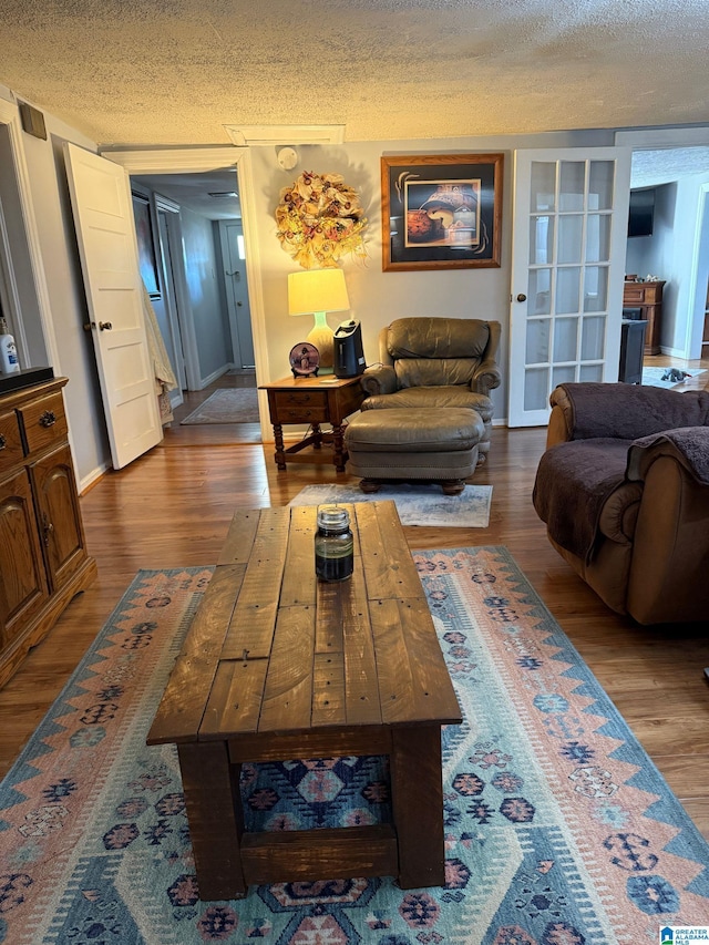 living room featuring a textured ceiling and light hardwood / wood-style flooring