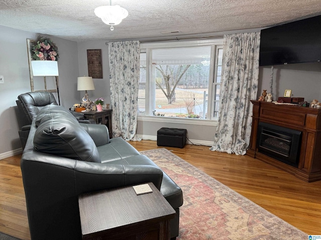 living room with hardwood / wood-style flooring and a textured ceiling