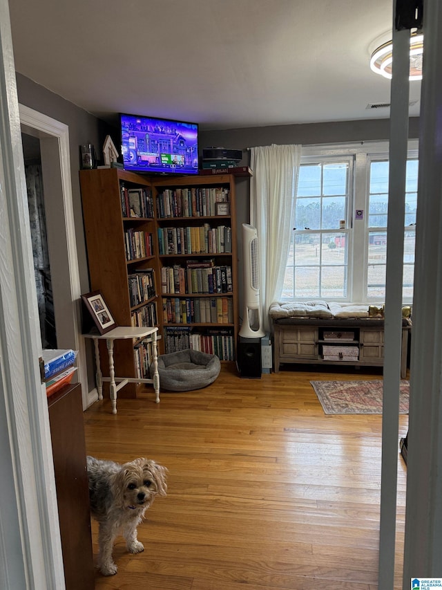 living area with hardwood / wood-style flooring