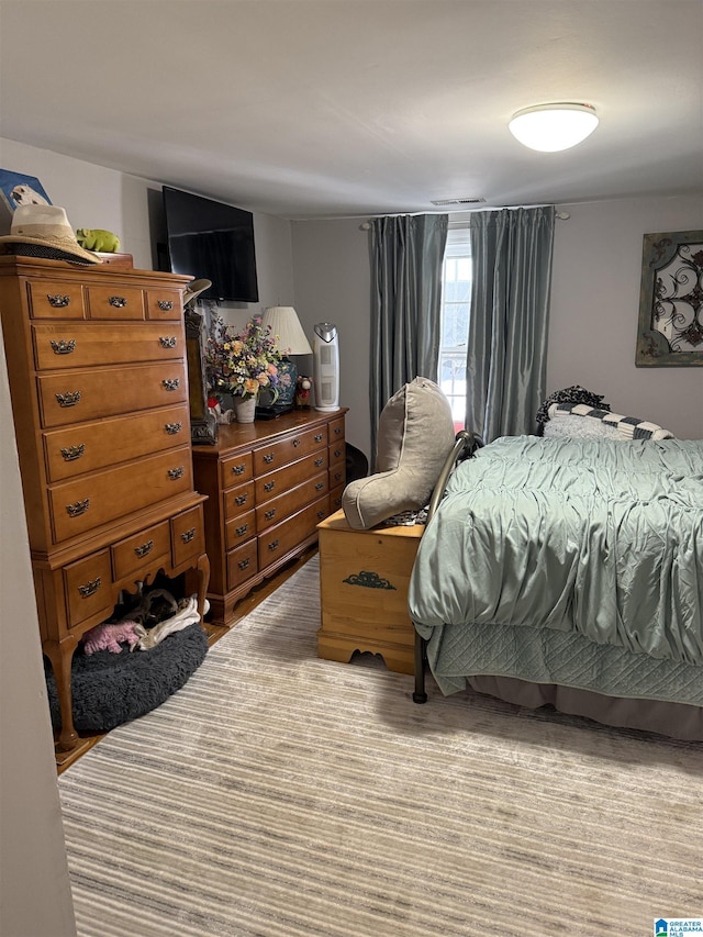 bedroom featuring visible vents