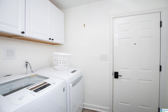 washroom with cabinets and separate washer and dryer