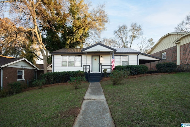 view of front facade featuring a front lawn and a carport