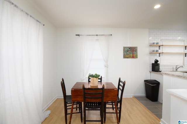 dining room with light wood-type flooring and sink