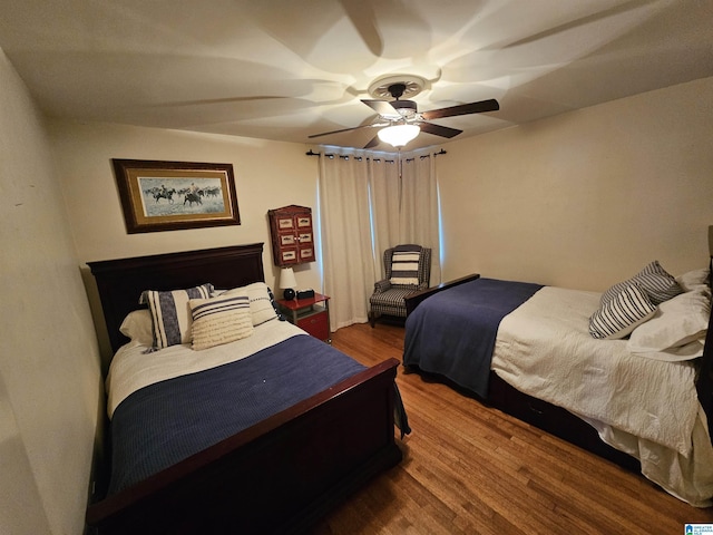 bedroom with hardwood / wood-style flooring and ceiling fan