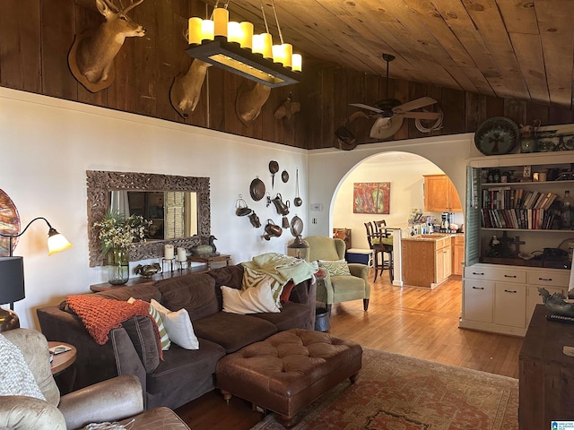 living room with wood ceiling, vaulted ceiling, light hardwood / wood-style floors, and ceiling fan