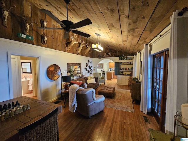 living room with ceiling fan, wood-type flooring, vaulted ceiling, and wooden ceiling