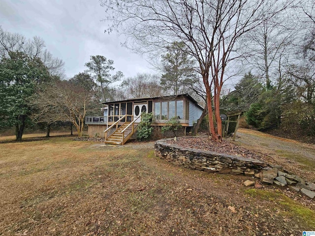 exterior space featuring a sunroom and a front yard