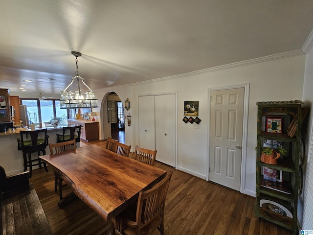 dining area with ornamental molding and dark wood-type flooring