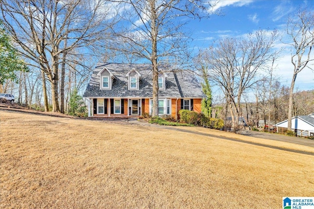 cape cod-style house with a front yard and a porch