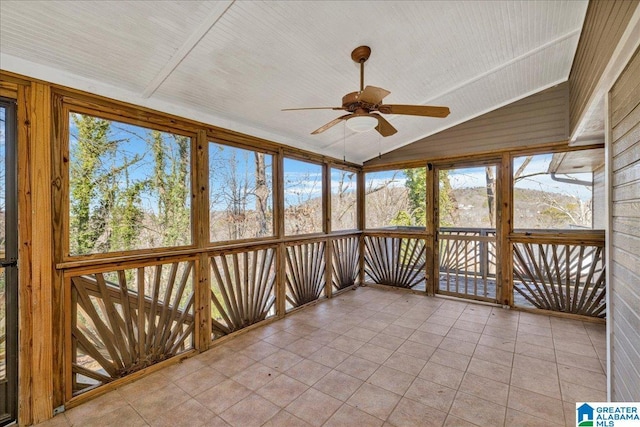 unfurnished sunroom featuring ceiling fan and vaulted ceiling