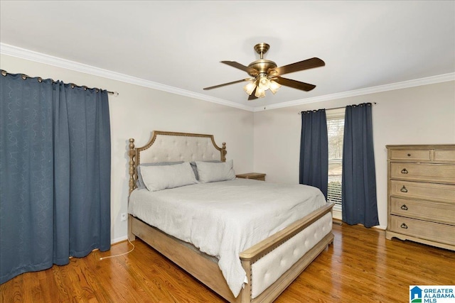 bedroom with ceiling fan, hardwood / wood-style floors, and ornamental molding