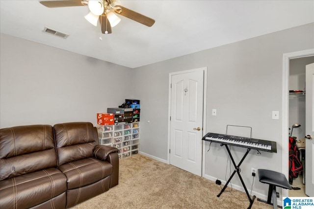 carpeted living room featuring ceiling fan