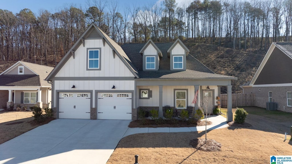 view of front of property featuring a garage and central AC unit