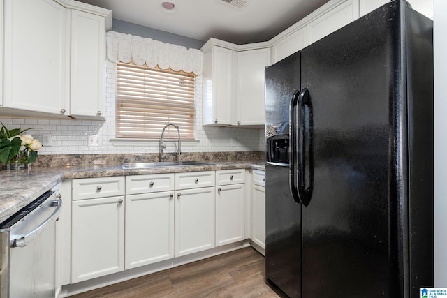 kitchen with black refrigerator with ice dispenser, dark hardwood / wood-style flooring, dishwasher, white cabinets, and sink