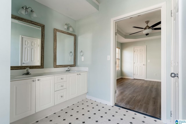 bathroom featuring ceiling fan, vanity, and ornamental molding