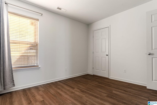 unfurnished bedroom featuring dark hardwood / wood-style floors