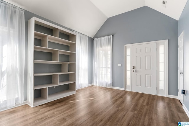 foyer with lofted ceiling and wood-type flooring