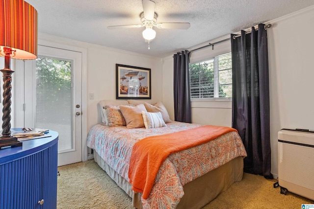 bedroom featuring a textured ceiling, ornamental molding, access to outside, ceiling fan, and light colored carpet